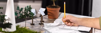 side-view-man-working-eco-friendly-wind-power-project-with-paper-plans